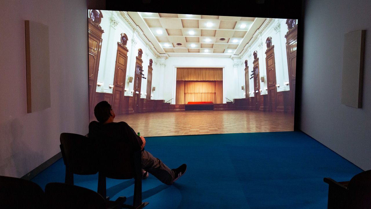Image of man sitting in front of a projector